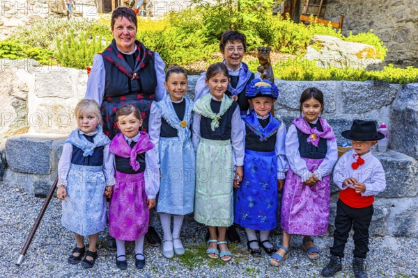 Women and children in traditional costumes, historic village centre, Grimentz, Val d'Anniviers, Valais Alps, Canton Valais, Switzerland