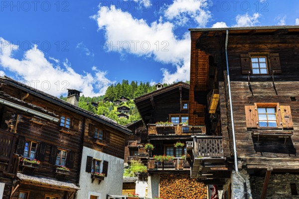 Old wooden houses in log construction, decorated with flowers, historic village centre, Grimentz, Val d'Anniviers, Valais Alps, Canton Valais, Switzerland