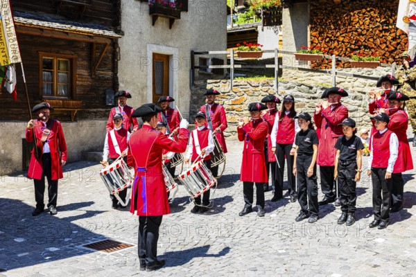 Pipers and drummers play in the historic village centre, Grimentz, Val d'Anniviers, Valais Alps, Canton Valais, Switzerland