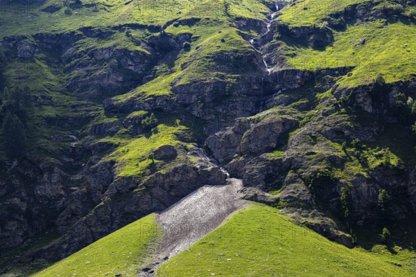 Waterfall and green slopes in a rock face, Zinal valley, Val d'Anniviers, Valais Alps, Canton Valais, Switzerland