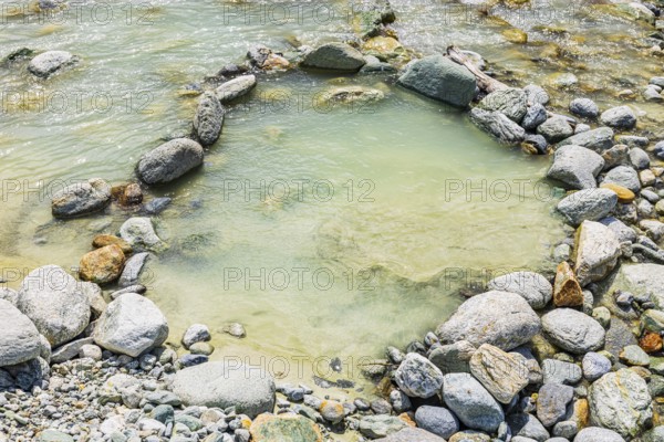Boulders form a circle in the mountain stream La Navisence, near Zinal, Val d'Anniviers, Valais Alps, Canton Valais, Switzerland