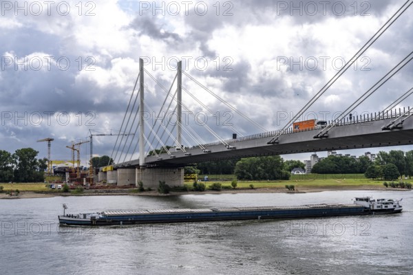 Rhine bridge Duisburg-Neuenkamp, the A40 motorway, start of construction of the second bridge, bridge piers and the first bridge segment are erected on the Neuenkamp side of the Rhine, cargo ship on the Rhine, North Rhine-Westphalia, Germany