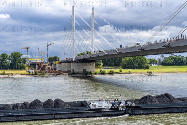 Rhine bridge Duisburg-Neuenkamp, the A40 motorway, start of construction of the second bridge, bridge piers and the first bridge segment are erected on the Neuenkamp side of the Rhine, cargo ship on the Rhine, with coal for a power station in Karlsruhe, North Rhine-Westphalia, Germany
