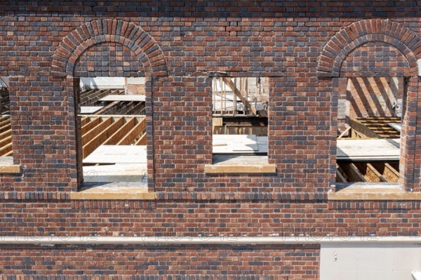 Detroit, Michigan - Workers rehab a long-vacant and crumbling commercial building in the Morningside neighborhood. The project, called Ultreia, will contain first floor commercial space and apartments above