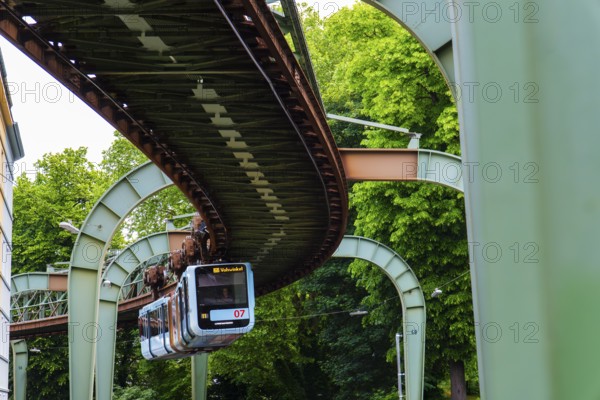 The Wuppertal suspension railway runs through Vohwinkel in front of buildings from the Wilhelminian era near the Hammerstein stop in Wuppertal, Germany