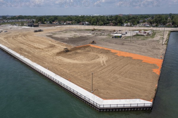 Detroit, Michigan - Workers spread clean dirt after old industrial contamination of cadmium, arsenic, lead, and other metals was removed from A.B. Ford Park on the Detroit River