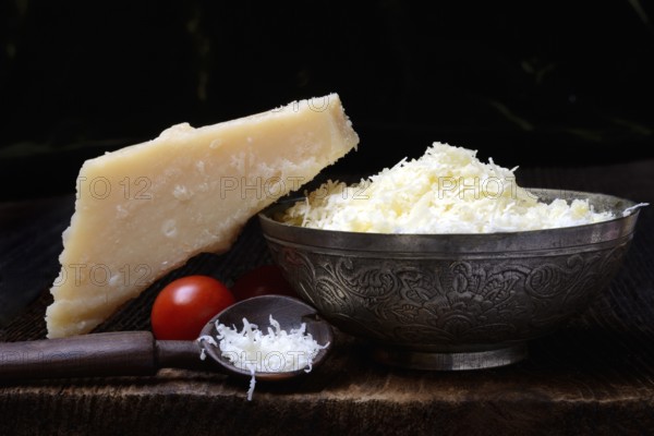 Parmesan cheese, grated cheese in rind and piece of Parmesan, Italy