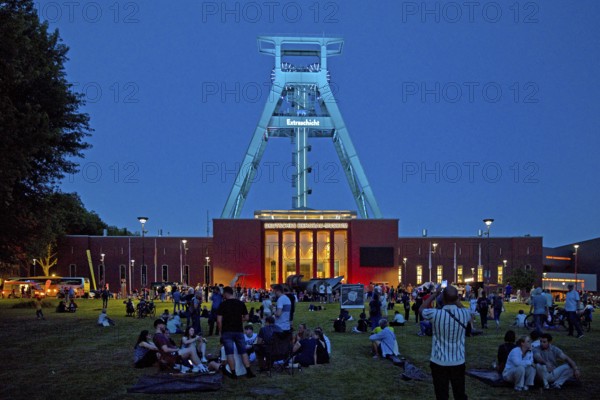 People in front of the German Mining Museum for the Extra Shift at night, Bochum, Ruhr Area, North Rhine-Westphalia, Germany