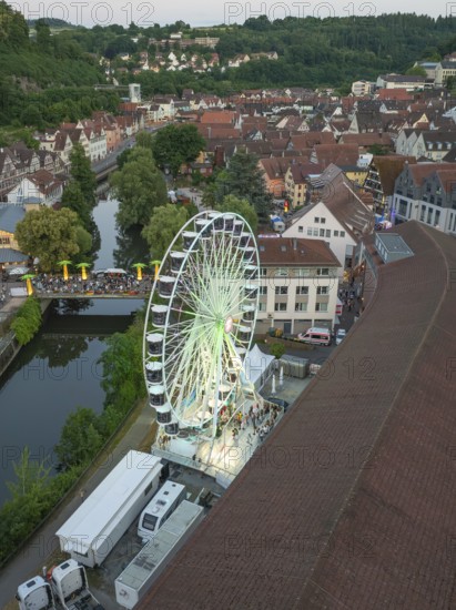 Ferris wheel in a town with river and surrounding houses from the air, 950 years Calw, Germany