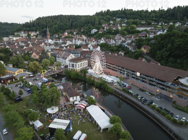 Urban festival with Ferris wheel and event tents next to a river, 950 years of Calw, Germany