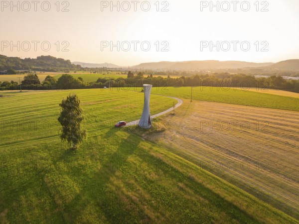 Extensive landscape with a viewing tower under a clear sky in a summery atmosphere