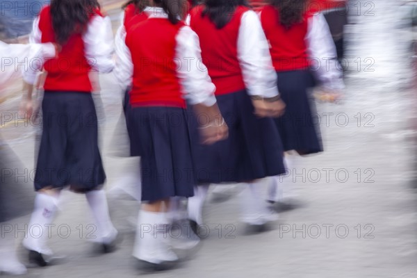 Group of female students walking to the college, Motion blur, City of Otavalo, Imbabura province, Ecuador, South America