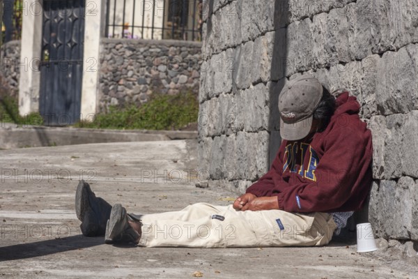 Man sleeping on the sidewalk, City of Otavalo, Imbabura province, Ecuador, South America