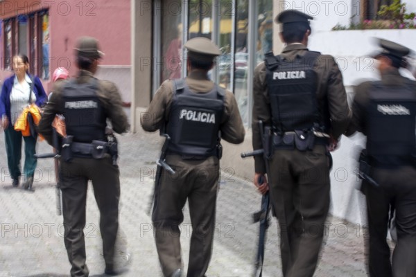 Policemen walking in the street, Motion blur, City of Quito. Pichincha province, Ecuador, South America