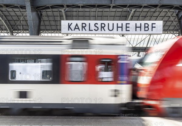 Karlsruhe main station with station sign and SBB InterCity. Karlsruhe, Baden-Württemberg, Germany