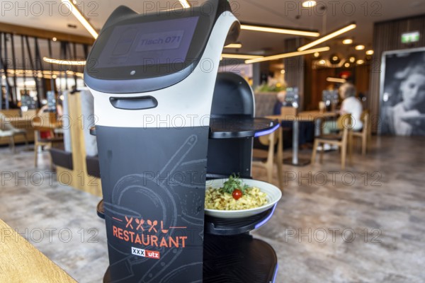 Furniture store XXXLutz Mann Mobilia Karlsruhe. In the restaurant, serving robot Lutzi supports the staff and brings the food to the table. Karlsruhe, Baden-Württemberg, Germany