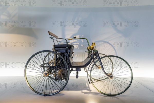 Daimler Motor-Quadricycle steel-wheeled carriage from 1889. The Mercedes-Benz Museum in Stuttgart presents a journey through the automotive history of the global corporation. The history of the Mercedes star begins with the first automobile in 1886. 160 vehicles are on display. Stuttgart, Baden-Württemberg, Germany