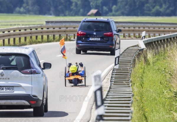 Man with handbike travelling on a country road. Special bike with manual drive for disabled people. Merklingen, Baden-Württemberg, Germany