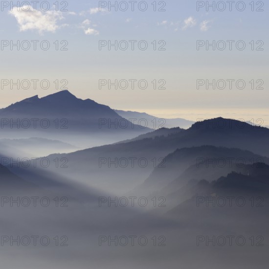 Mountain silhouettes... Alpine peaks and mountain ranges in the Bavarian Alps, light fog rises from the valleys, which creates an idyllic atmosphere in the light of the low sun, romantic view from Oberstdorf towards Kleinwalsertal, local nature, Bavaria, Allgäu, Allgäu Alps, Bavarian, Germany, Western Europe