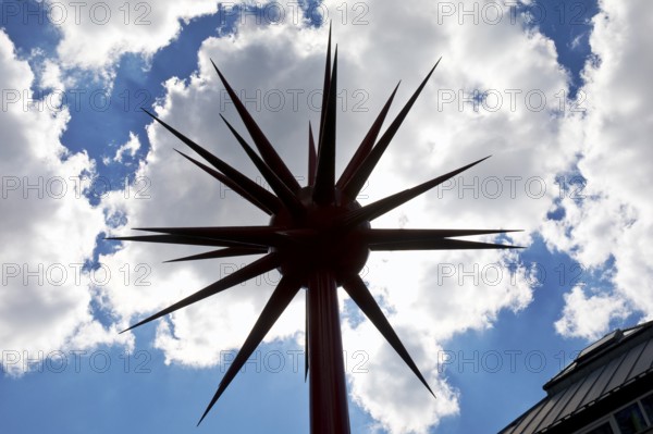 Work of art by Otto Piene entitled Fireworks for Celle as a silhouette against the light in front of clouds, Lower Saxony, Germany