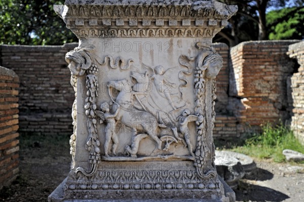 Relief on the sacred altar of Romulus and Remus, Sacello dell' Ara di Romolo e Remo, angel, chariot, stone carving, remains, ruins, ancient port city of Rome, excavation site Archaeological Park Ostia Antica, metropolitan city of Rome, Lazio, Italy