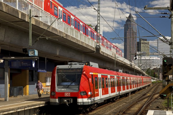 Two regional express trains on different levels at Frankfurt West station with Messeturm, Frankfurt am Main, Hesse, Germany