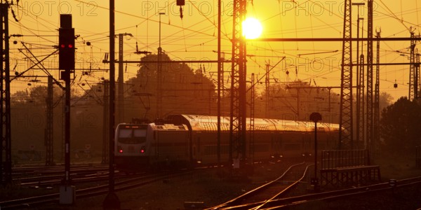 Travelling train at sunrise, Central Station, Dortmund, Ruhr Area, Germany
