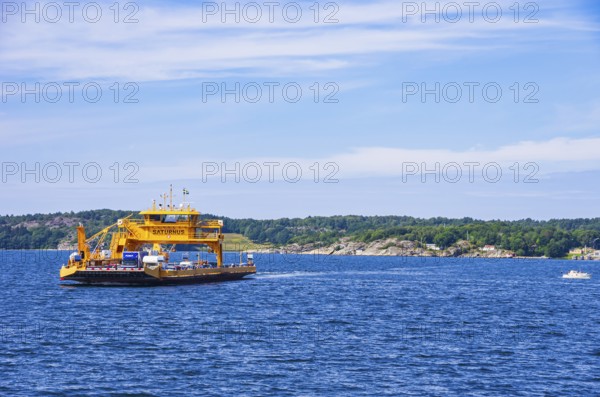 The car ferry SATURNUS, which operates as a floating road between the archipelago, navigates off the coast near Lysekil, Bohuslän, Västra Götalands län, Sweden, Scandinavia