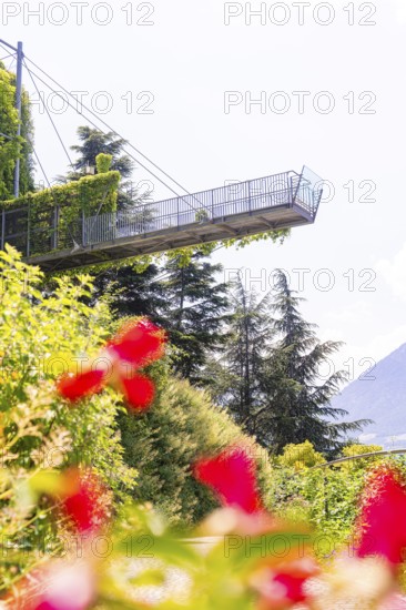 A modern viewing platform towers over colourful flowers and overlooks the mountains, Botanical Gardens, The Gardens of Trauttmansdorff Castle, Merano, South Tyrol, Italy