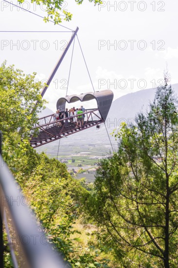 People on a floating platform in a mountainous landscape with green surroundings, Botanical Garden, The Gardens of Trauttmansdorff Castle, Merano, South Tyrol, Italy