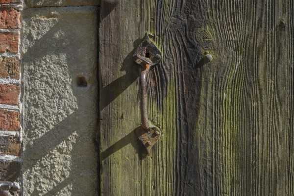 Old wooden door with iron fittings, Münsterland, North Rhine-Westphalia, Germany