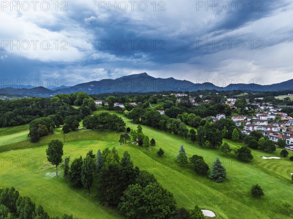 Sunset and storm clouds over Pyrenees and Saint-Jean-de-Luz from a drone, Nouvelle-Aquitaine, Pyrenees-Atlantiques, France
