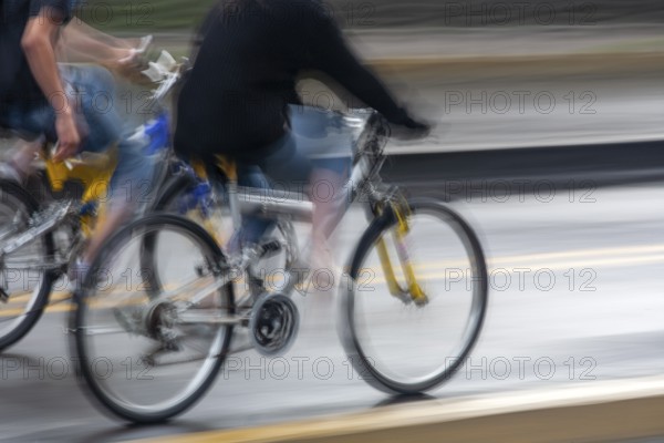 People riding bicycles, Photo with motion blur, City of Quito, Pichincha province, Ecuador, South AmericaCity of Quito. Pichincha province. Ecuador. South America