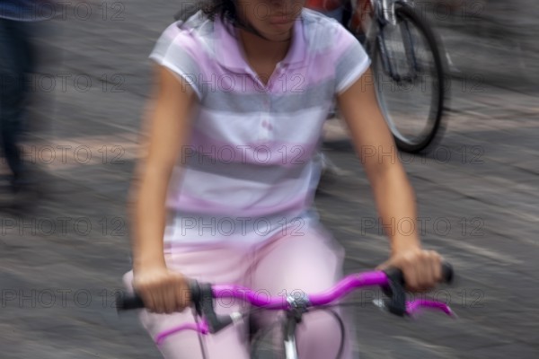 Woman riding a bicycle, Photo with motion blur, City of Quito, Pichincha province, Ecuador, South America