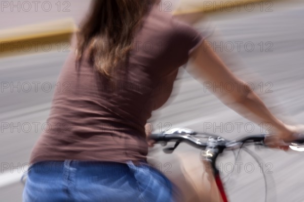 Woman riding a bicycle, Photo with motion blur, City of Quito, Pichincha province, Ecuador, South America