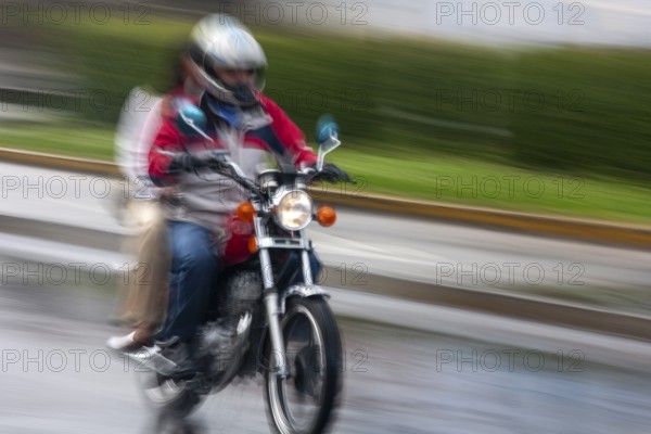 Man riding a motorcycle, Riding at high speed, Photo with motion blur, City of Quito, Pichincha province, Ecuador, South America