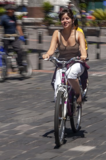 Woman riding a bicycle, Photo with motion blur, City of Quito, Pichincha province, Ecuador, South America