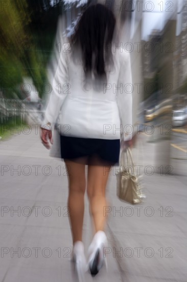 Woman walking in street, Photo with motion blur, City of Quito, Pichincha province, Ecuador, South America