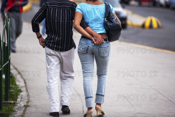 Couple walking in street, Hand in hand, City of Quito, Pichincha province, Ecuador, South America