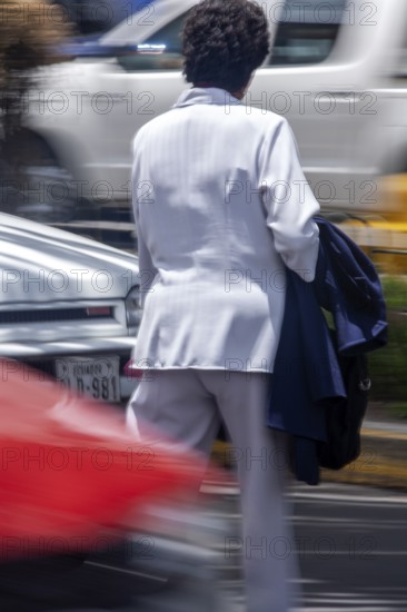 Woman crossing a street, Photo with motion blur, City of Quito, Pichincha province, Ecuador, South America