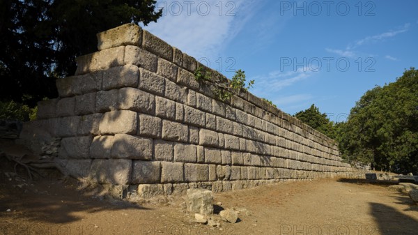 Stone wall in a natural setting with clear blue sky, Wall Upper Terrace, Asklipion, Asklepieion, Healing Temple, Temple, Hippocrates, Kos, Dodecanese, Greek Islands, Greece