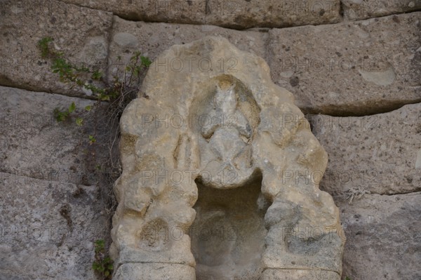 Stone sculpture in ancient wall with natural vegetation, arcade, lower terrace, Pan, Asklipion, Asklepieion, healing temple, temple, Hippocrates, Kos, Dodecanese, Greek Islands, Greece