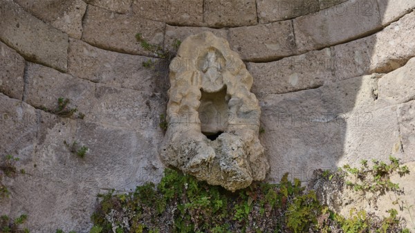 Sculpture in an ancient round arch, surrounded by plants and masonry, arcade, lower terrace, Pan, Asklipion, Asklepieion, healing temple, temple, Hippocrates, Kos, Dodecanese, Greek Islands, Greece