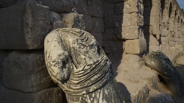 Broken ancient statue on a ruined stone wall illuminated by sunlight, ancient statue of the gods, Asklipion, Asklepieion, healing temple, temple, Hippocrates, Kos, Dodecanese, Greek Islands, Greece