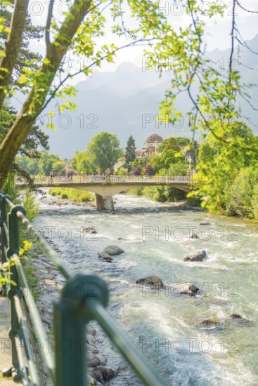 Scenic view of a river with bridge and trees in the background, Merano, Italy