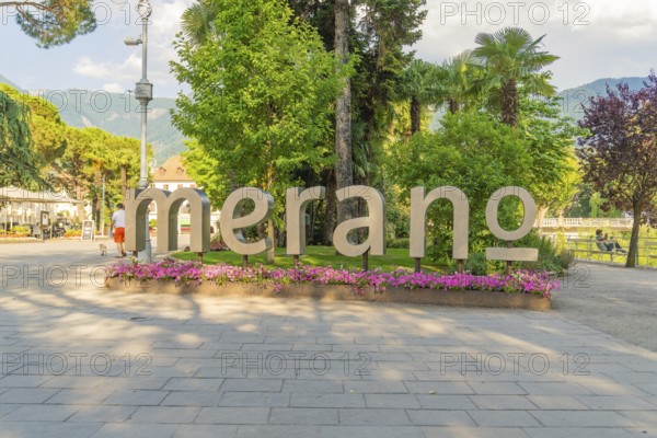 Large 'Merano' lettering surrounded by trees and flowers, Merano, Italy