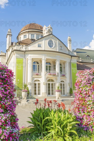 Baroque building with elaborate floral decorations and clear sky in the background, Merano, Italy