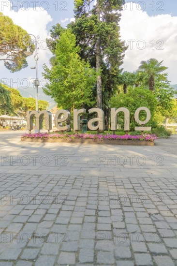 Large lettering 'Merano' in a park decorated with flowers, Merano, Italy