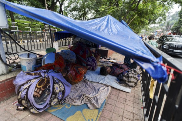 A devotee takes a nap in a street divider, as he arrives to visit Kamakhya Temple during Ambubachi Mela, in Guwahati, India on June 22, 2025. The Ambubachi Mela is one of the most spiritually significant and culturally unique festivals in India