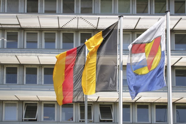 Three flags at the job centre, modern building with window, national flag, Baden-Württemberg state flag and city flag with city coat of arms, city administration, Pforzheim, Northern Black Forest, Black Forest, Baden-Württemberg, Germany